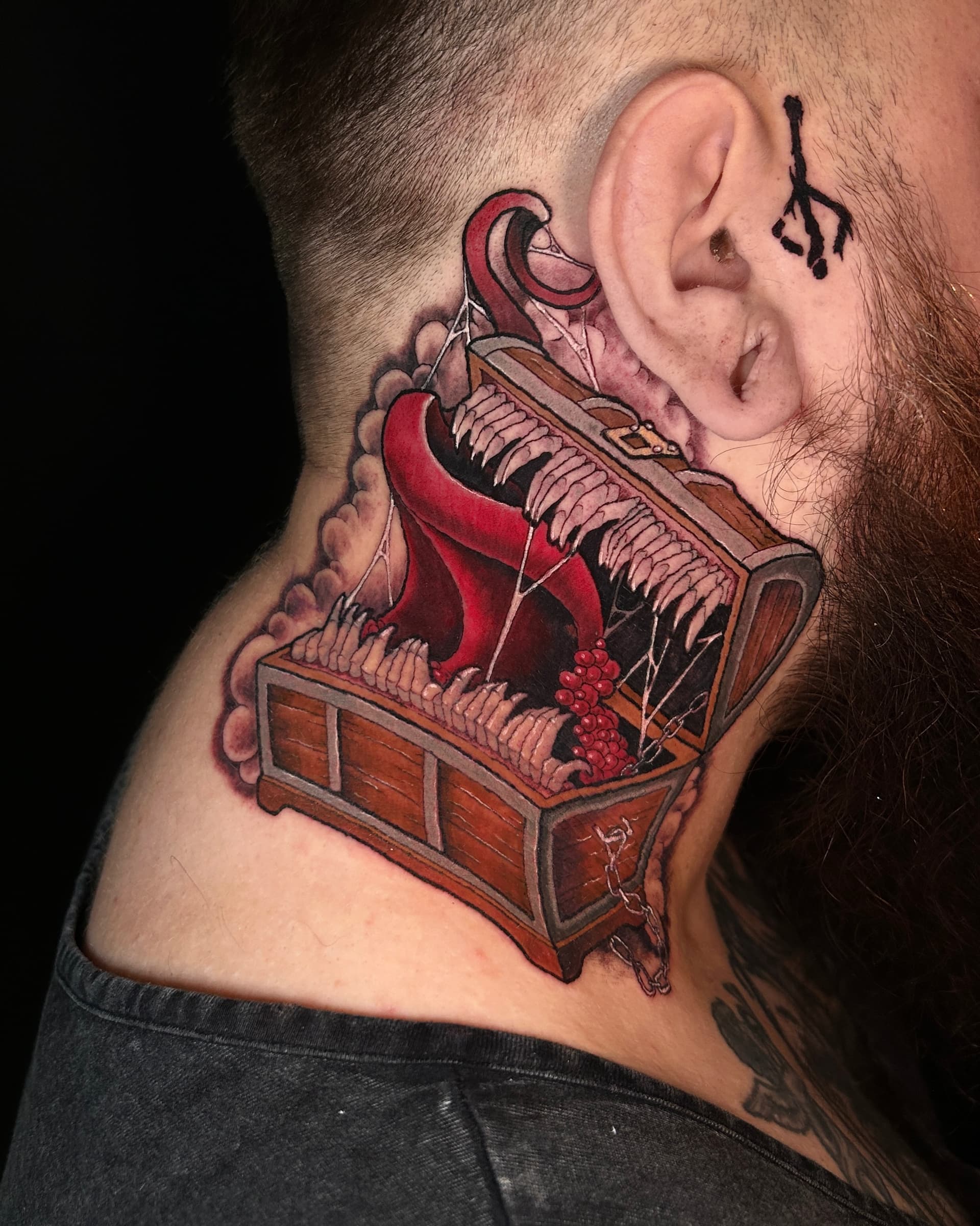 Neo traditional tattoo of a mimic chest with sharp teeth and a long tongue — bold Dark Souls-inspired fantasy design