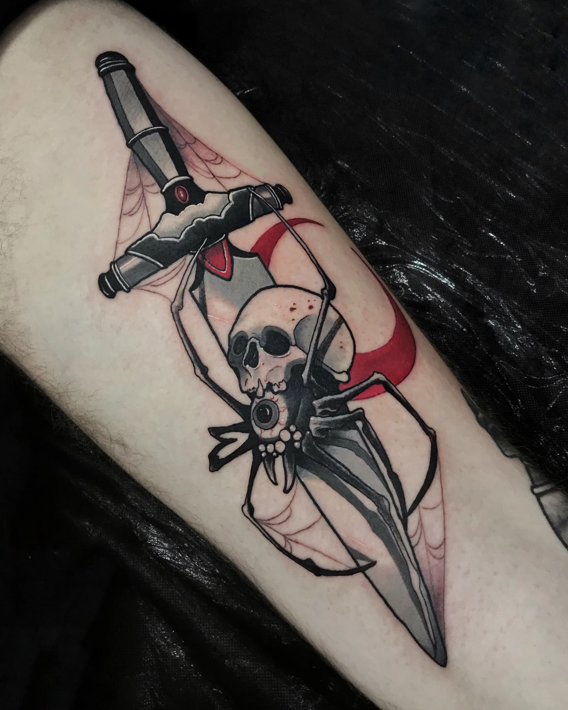 Neo traditional tattoo of a spider with a skull body and dagger — dark illustrative color design